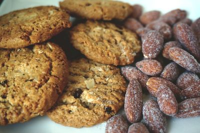 Close-up of cookies and almonds in plate