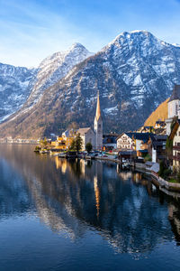 View of beautiful hallstatt lake and famous church during morning sunrise in spring with mountains