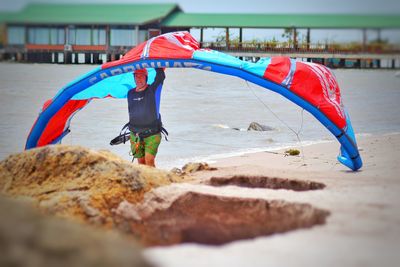 Full length of man with umbrella on beach