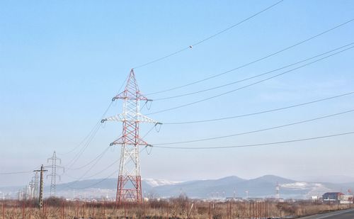 Low angle view of electricity pylon against sky