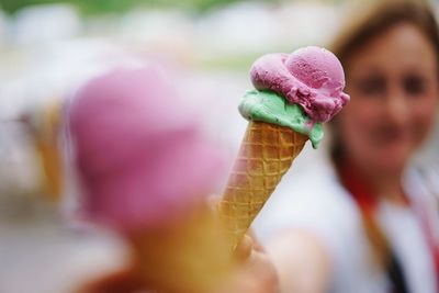 Cropped image of woman having ice cream with friend