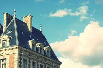 Low angle view of building against blue sky