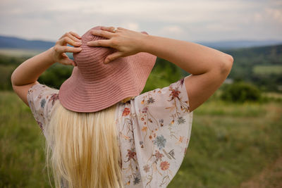 Rear view of woman standing on field