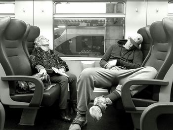 View of man sleeping in train
