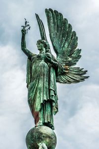 Low angle view of statue against cloudy sky