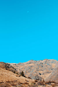 Scenic view of desert against clear blue sky