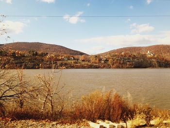 Scenic view of lake and mountains against sky