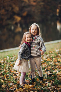 Full length of girl with autumn leaves