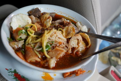 High angle view of noodle soup with spring rolls served in bowl