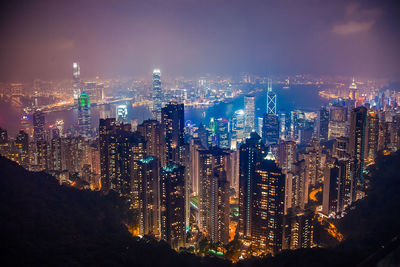 Close-up of illuminated cityscape against sky at night