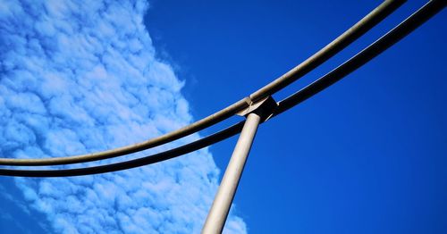 Low angle view of telephone pole against blue sky