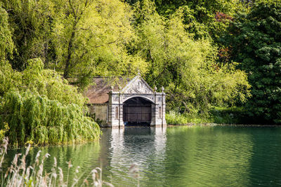 Gazebo by lake in forest