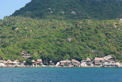 Scenic view of sea and buildings against sky