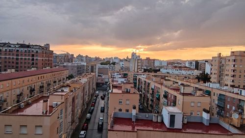 High angle view of buildings in city against sky during sunset