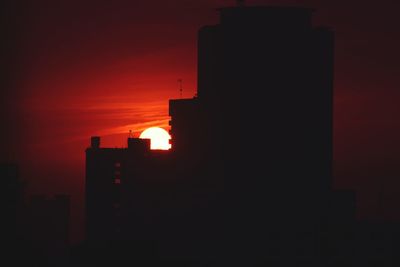 Silhouette of factory at sunset