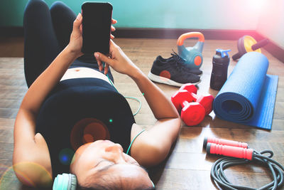 Midsection of woman photographing with mobile phone