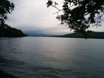 Scenic view of sea and mountains against sky