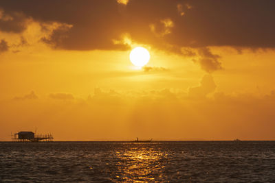 Scenic view of sea against orange sky