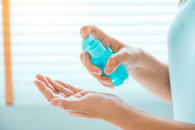 Close-up of woman hand holding bottle