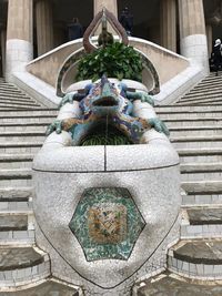 Low angle view of buddha statue against wall