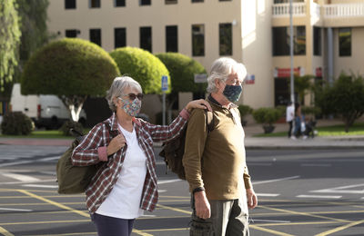 Senior couple wearing mask outdoors