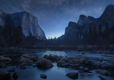 Scenic view of rocks against sky at night during winter