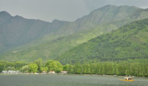 Scenic view of river with mountains in background