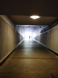 Man walking in illuminated tunnel
