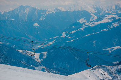 Overhead cable car over snowcapped mountains