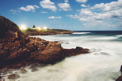 View of rocky beach against sky