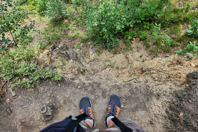 Low section of person standing on field