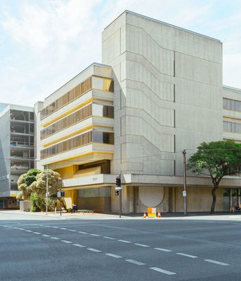 ROAD BY BUILDINGS AGAINST SKY