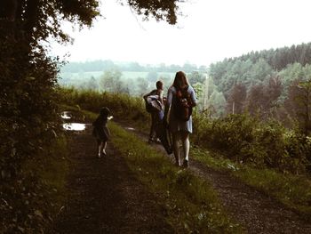 People walking on land in forest