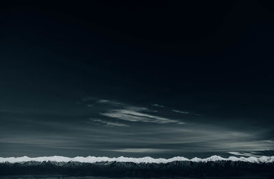 Scenic view of snowy field against sky at night