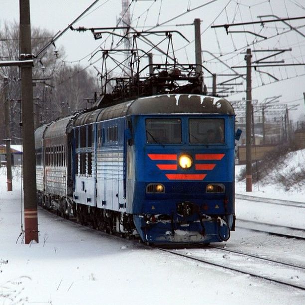 transportation, railroad track, mode of transport, train - vehicle, rail transportation, public transportation, land vehicle, snow, railroad station, railroad station platform, winter, passenger train, cold temperature, car, travel, train, sky, electricity pylon, no people, power line