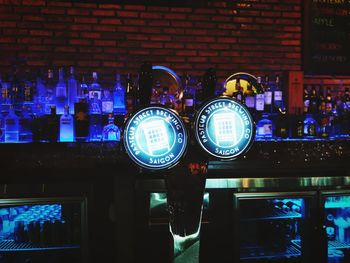 Close-up of illuminated lighting equipment on brick wall