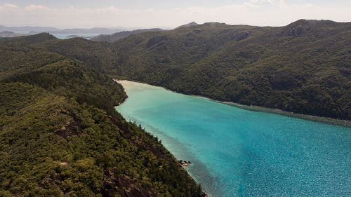 Scenic view of sea and mountains against sky