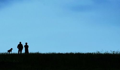 Man standing on field against clear sky