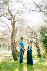 Full length of couple standing in park