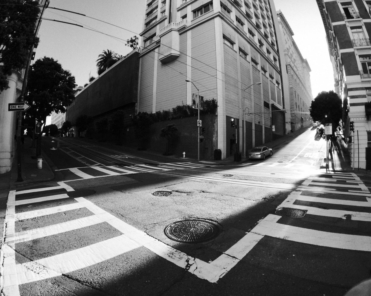 Empty road with buildings in background