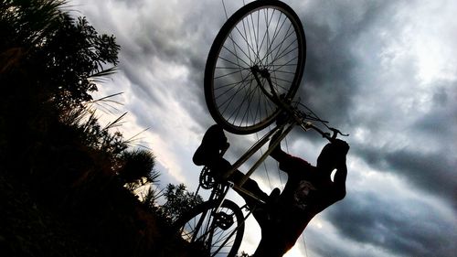 Low angle view of silhouette bicycle against sky