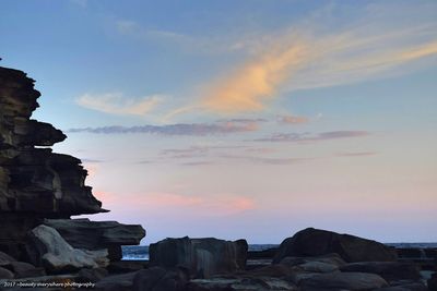 Low angle view of rocks against sky