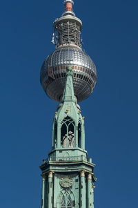 Low angle view of clock tower and fernsehturm