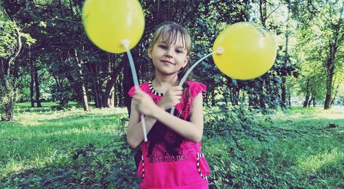 Full length of a girl holding balloons