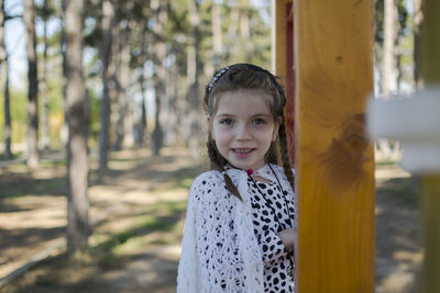 Portrait of smiling girl standing outdoors