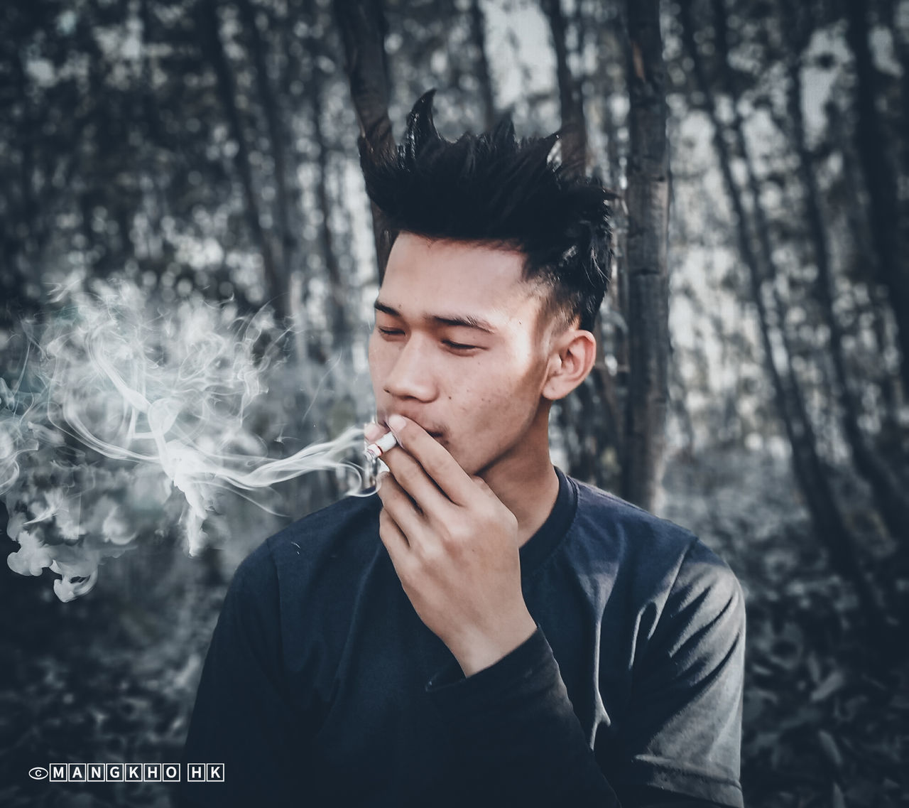 smoke - physical structure, one person, young adult, tree, smoking - activity, young men, real people, cigarette, smoking issues, bad habit, activity, headshot, forest, social issues, lifestyles, plant, risk, leisure activity, human face