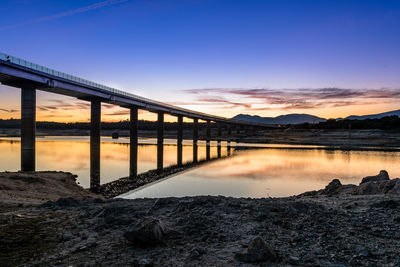 Scenic view of river against sky during sunset