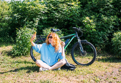 A young woman uses a modern electric bicycle for sports and outdoor recreation