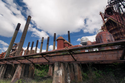 Low angle view of built structure against cloudy sky