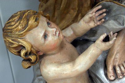 Close-up of angel statue at altar against wall